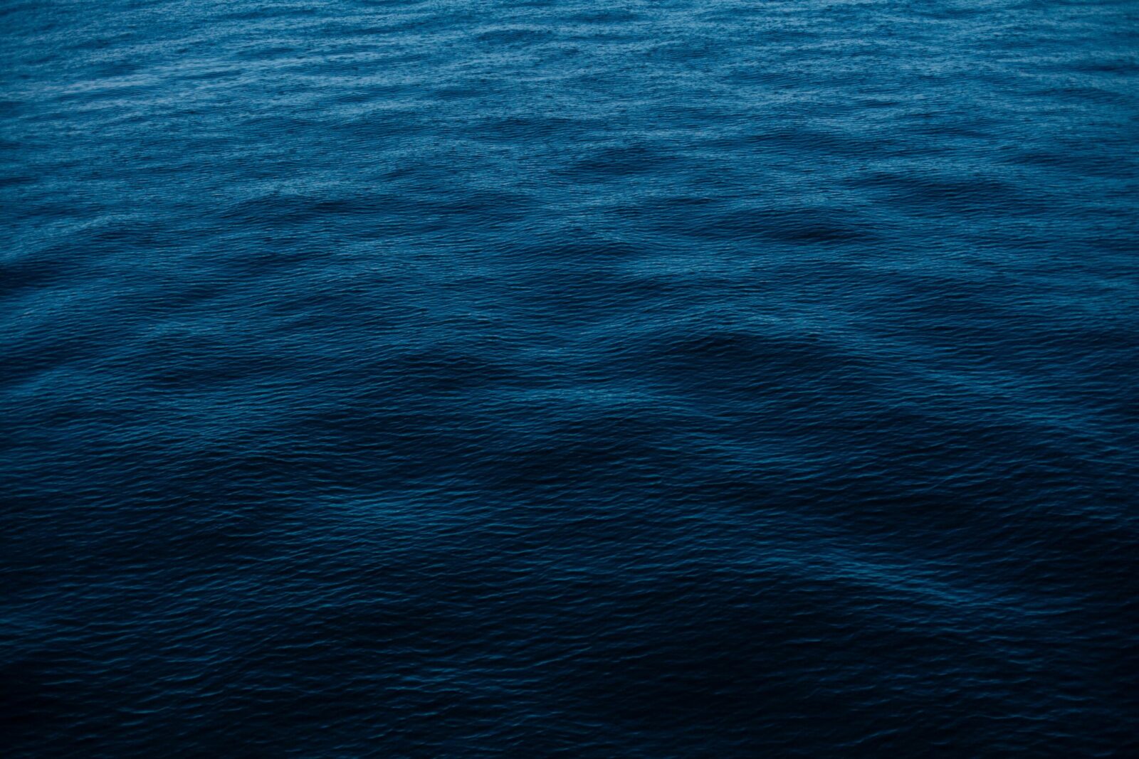 Vivid depiction of deep blue ocean surface, perfect for backgrounds and wallpapers.